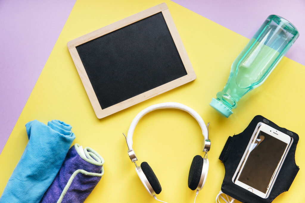 blackboard-near-smartphone-bottle-with-towels