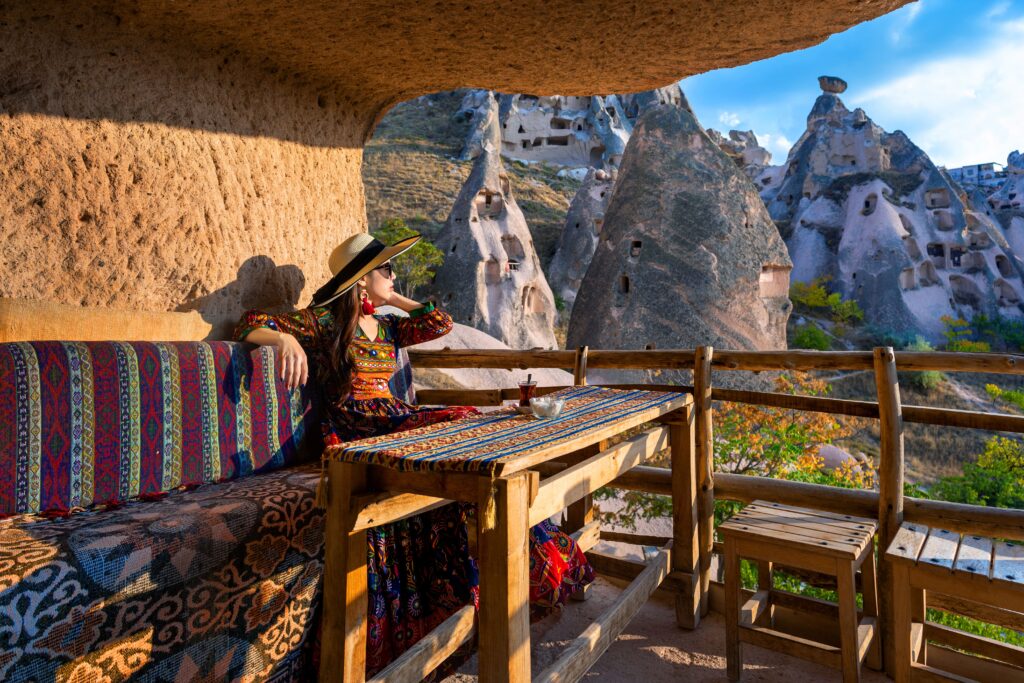 woman-bohemian-dress-sitting-traditional-cave-house-cappadocia-turkey 