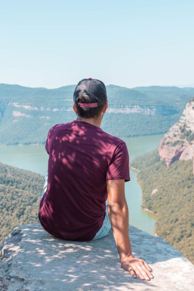 10 Affordable Travel Destinations for 2025 A traveler enjoying a scenic view of mountains on a budget trip