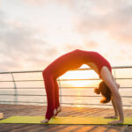 10 Morning Habits That Can Transform Your Health and Boost Your Energy A person doing yoga at sunrise as part of a healthy morning routine